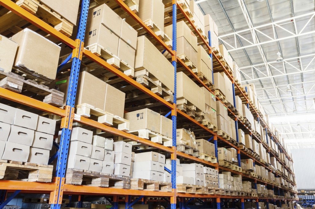 Rows of shelves with boxes in modern warehouse